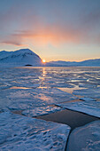 Midnight sun over ice floes in late winter, Svalbard, Spitsbergen, Norway