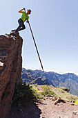 man jumping with the canarian crook, Salto del Pastor Canario, Pared de Roberto, basaltic rock, crater rim, Caldera de Taburiente, UNESCO Biosphere Reserve, La Palma, Canary Islands, Spain, Europe