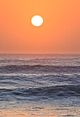 Sun setting over ocean, Cape Cross, Namibia