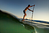 Young Stand Up Paddler on Lake Starnberg,  Lake Starnberg, Bavaria, Germany