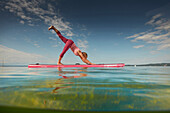 Yoga Teacher on SUP Board,  Lake Starnberg, Bavaria, Germany