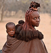 Married Himba woman with child, Kaokoveld Desert, Namibia