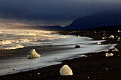 Ice chunks on coast after a storm at sunset, Jokulsarlon, Iceland