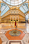 Woman walking in Galleria Vittorio Emanuele II shopping mall, Milan, Lombardy, Italy