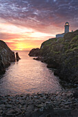 Fanad Head (Fánaid) lighthouse, County Donegal, Ulster region, Ireland, Europe. Pink sunset at Fanad Head