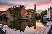 The medieval Belfry and historic buildings reflected in Rozenhoedkaai canal at dusk, Bruges,flemish region, West Flanders, Belgium, Europe