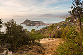 Tourist on a bench admiring the panoramic view from Punta Manara, Sestri Levante, Genova Province, Liguria, Italy