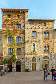 Tourists in the square of San Gimignano. Italy, Tuscany, Siena district.
