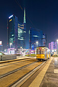 View of the Unicredit Tower spire from the tram stop of avenue Luigi Sturzo during the evening. Milan, Lombardy, Italy.