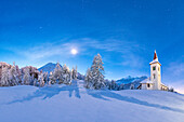 Moonlight on Chiesa Bianca surrounded by snow, Maloja, Bregaglia Valley, Canton of Graubunden, Engadin, Switzerland