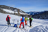 Several persons backcountry skiing having a break, Medalges, Natural Park Puez-Geisler, UNESCO world heritage site Dolomites, Dolomites, South Tyrol, Italy
