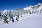 Three persons backcountry skiing ascending towards Wildalpjoch, Wildalpjoch, Bavarian Alps, Upper Bavaria, Bavaria, Germany