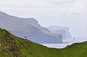 Man jumping on cliffs, Kalsoy island, Faroe Islands, Denmark