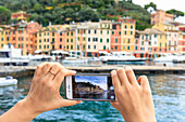 Tourist takes picture of smartphone, Portofino, province of Genoa, Liguria, Italy