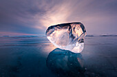 Piece of ice with sun reflection at lake Baikal, Irkutsk region, Siberia, Russia