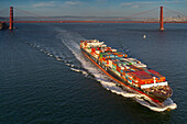 Freighter sailing against Golden Gate Bridge, San Francisco, California, USA