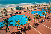 Aerial view of children playing in public pools near promenade of Golden Mile on Durban, South Africa