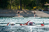 Photograph with prototype two-man personal submarine partially submerged in Lake Tahoe, California, USA