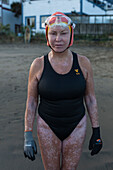 front view of woman in swimsuit and swimming cap, Dolphin Club, San Francisco, California, USA