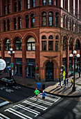 High angle view of two male runners crossing road at Pioneer Square, Seattle, Washington State, USA
