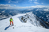 Woman backcountry-skiing ascending towards Faschauereck, Faschaunereck, Ankogel Group, Hohe Tauern range, Carinthia, Austria