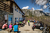 Many persons sitting at hut rifugio Nino Percin, rifugio Nino Percin, lake Garda, Garda Mountains, Trentino, Italy