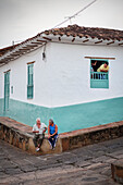 tow old men sitting at the pavement and having a conversation, Barichara, Departmento Santander, Colombia, Southamerica