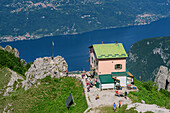 Hut rifugio Rosalba and lake lago di Como, from Grignetta, Grigna, Bergamasque Alps, Lombardy, Italy