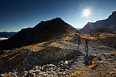 Hikers on the path to Lamsenspitze, Schafjoechl in the back,  Eastern Karwendel Range, Tyrol, Austria