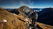 two hikers on the path to Sonnjoch, falzthurn valley under clouds,  Eastern Karwendel Range, Tyrol, Austria