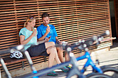 Young  woman young man eating ice cream; bicycle, Muensing, bavaria, germany