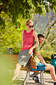 Young  woman young man having a break on bicycle tour, Kochel, bavaria, germany