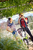 Young  woman and young man on eBike in front of an airstream trailer, Muensing, bavaria, germany