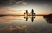 Young  woman on touring bike, young man on touring eBike on tour, lakeshore, Muensing, lake starnberg, bavaria, germany