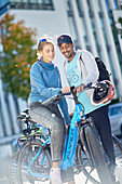 Young  woman young man witheBikes downtown, Munich, bavaria, germany