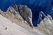 Several persons ascending through rocky cirque towards Lamsenspitze, Hochnissl in background, Lamsenspitze, Natural Park Karwendel, Karwendel range, Tyrol, Austria