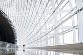 man walking along window corridor, interior architeture of National Centre for the Performing Arts, National Grand Theatre, Beijing, China, Asia, Architect Paul Andreu