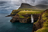 Múlafossur waterfall drops into the Atlantic ocean close by the village of Gásadalur, Vagar, Faroe islands