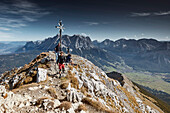 Two Hikers leaving the top of Daniel Mountain, Daniel mountain, Ammergau Alps, Tyrol, Austria