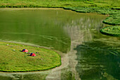 Two tents standing at lake Lac Cerces, lake Lac Cerces, Dauphine, Dauphiné, Hautes Alpes, France