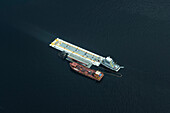 Aerial of two ships docked next to a gasoline station in the middle of the Rio Negro, a major tributary of the Amazon River, Manaus, Amazonas, Brazil, South America