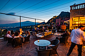 Sunset view from the terrace of the Grand Hotel Timeo to the volcano etna and Taormina, Sicily, South Italy, Italy