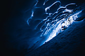 Snowboarder rides in an ice cave, Pitztal, Austria,