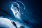 Snowboarder rides in an ice cave, Pitztal, Austria,