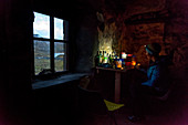 Evening cooking in Suileag Bothy, Inverpolly Nature Reserve, Highlands, Scotland, UK