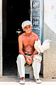 Old man and rooster in Trinidad, Trinidad and Sancti Spiritus Province, Cuba