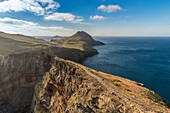 Hiker walking on the trail to Point of Saint Lawrence. Canical, Machico district, Madeira region, Portugal.