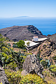 View of the small chapel Ermita de Nuestra Senora de Guadalupe and the Atlantic Ocean in Garajonay National Park, Valle Gran Rey, La Gomera, Canary Islands, Spain