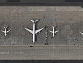 Aerial view airplanes parked on tarmac at airport