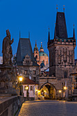 The Lesser Town Bridge Tower and St. Nicholas Church seen from Charles Bridge at dawn, UNESCO World Heritage Site, Prague, Bohemia, Czech Republic, Europe